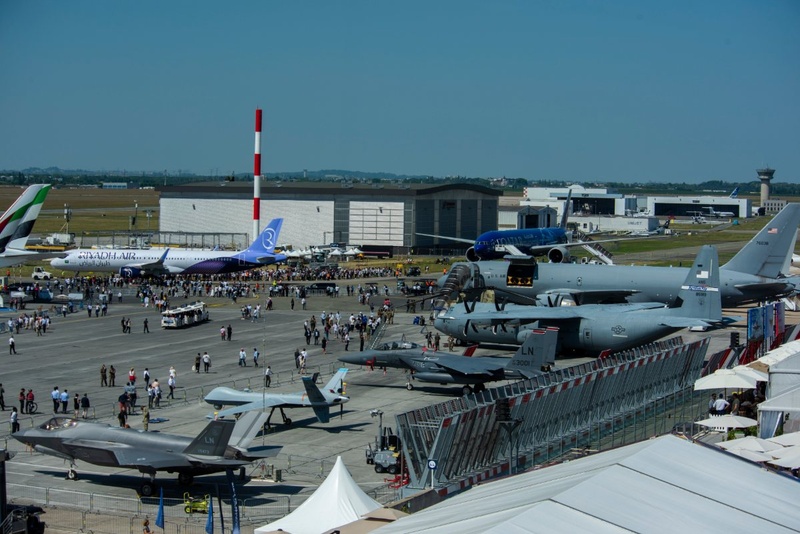 Aircraft on static display at Le Bourget, with visitors walking between them.